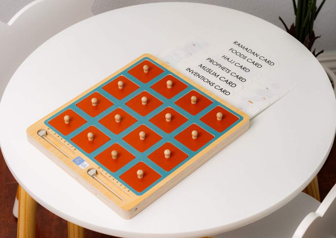 Muslim children playing the Lil Crescent Islamic memory matching game — orange wooden tiles face-down on wooden board with Islamic illustration cards