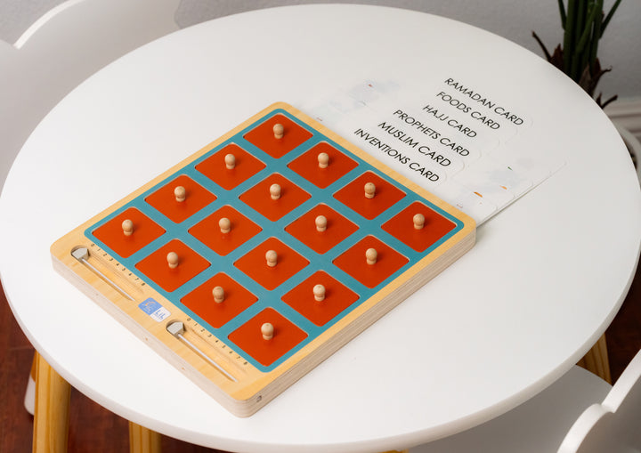 Muslim children playing the Lil Crescent Islamic memory matching game — orange wooden tiles face-down on wooden board with Islamic illustration cards